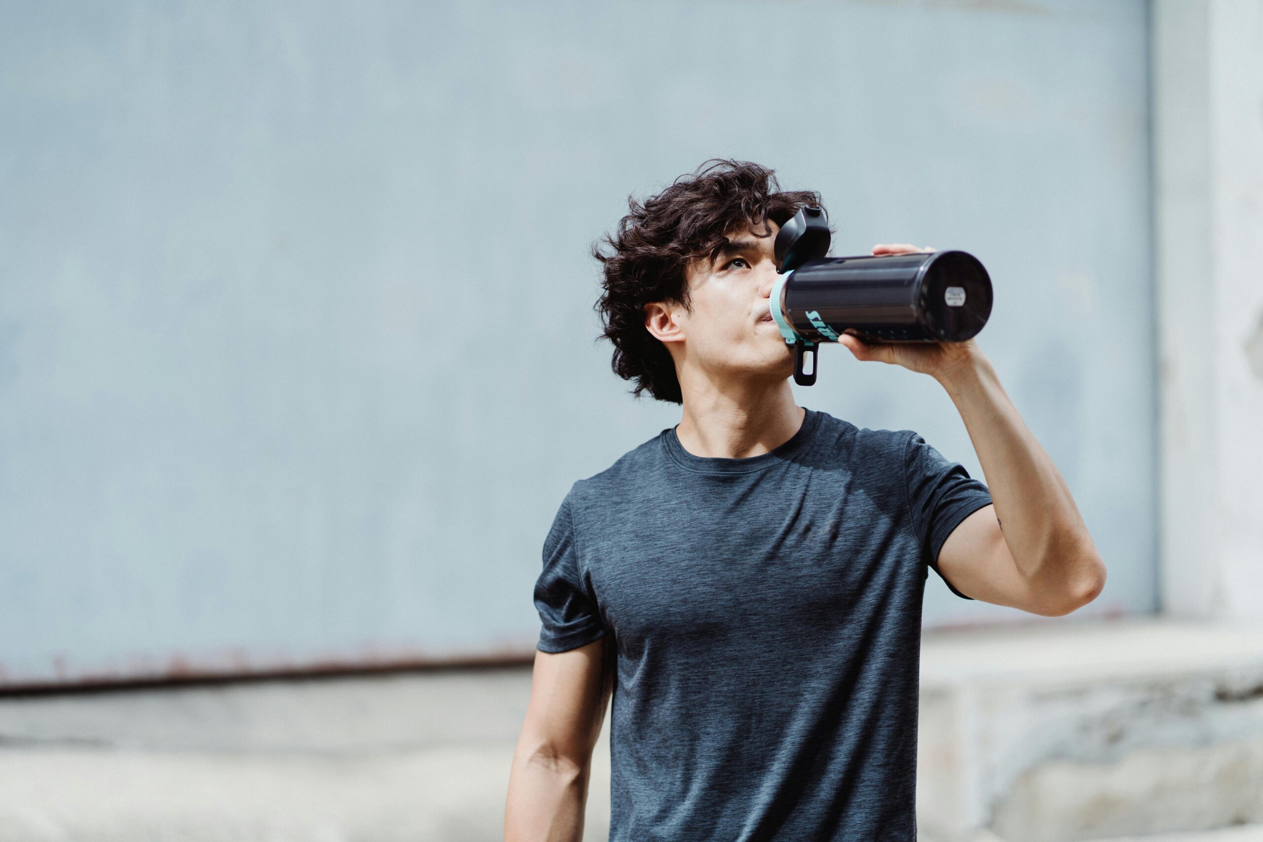 man drinking water -hydration strategies
