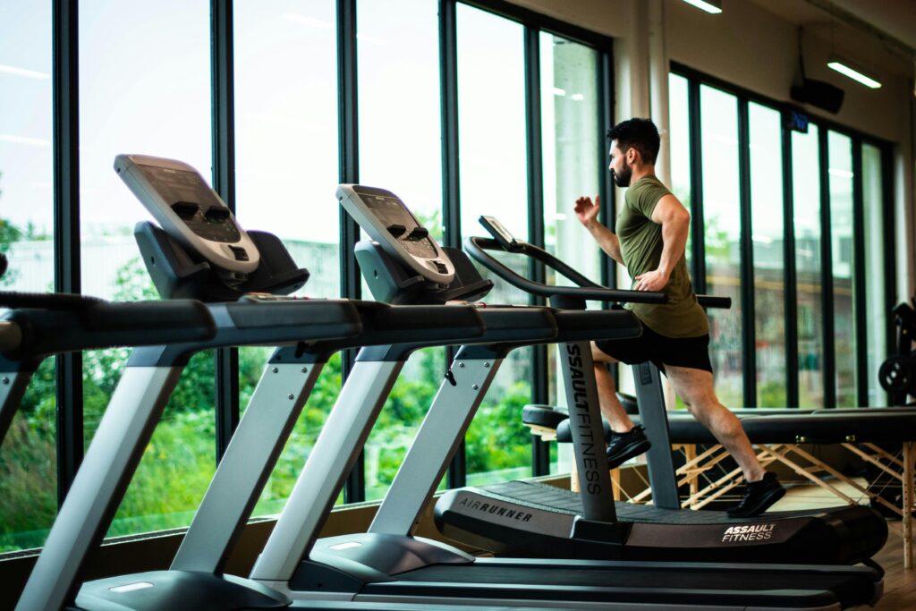 common gym terms machines for newbies - man at the gym running on treadmill