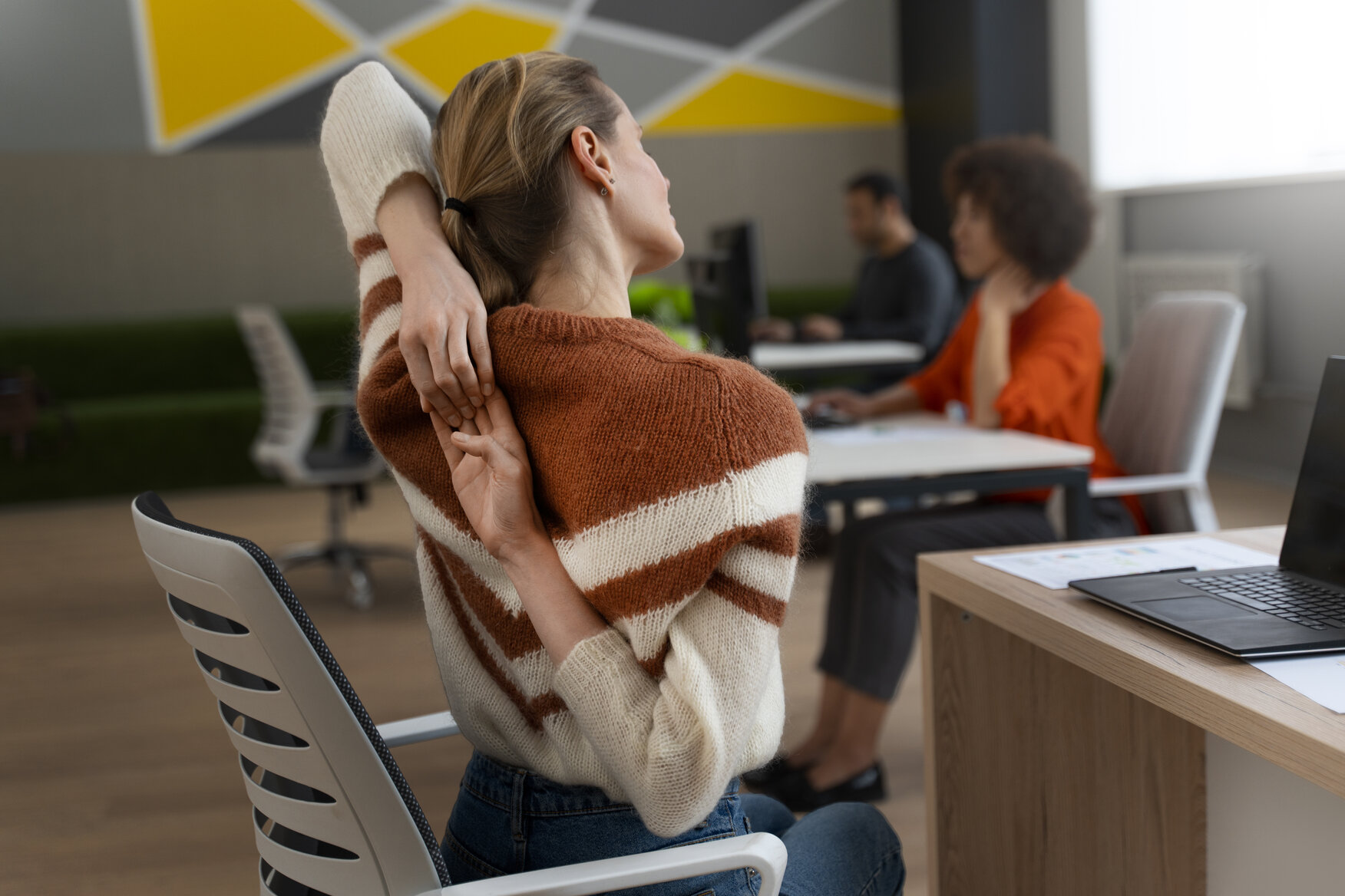 woman in office doing daily mobility flow by stretching