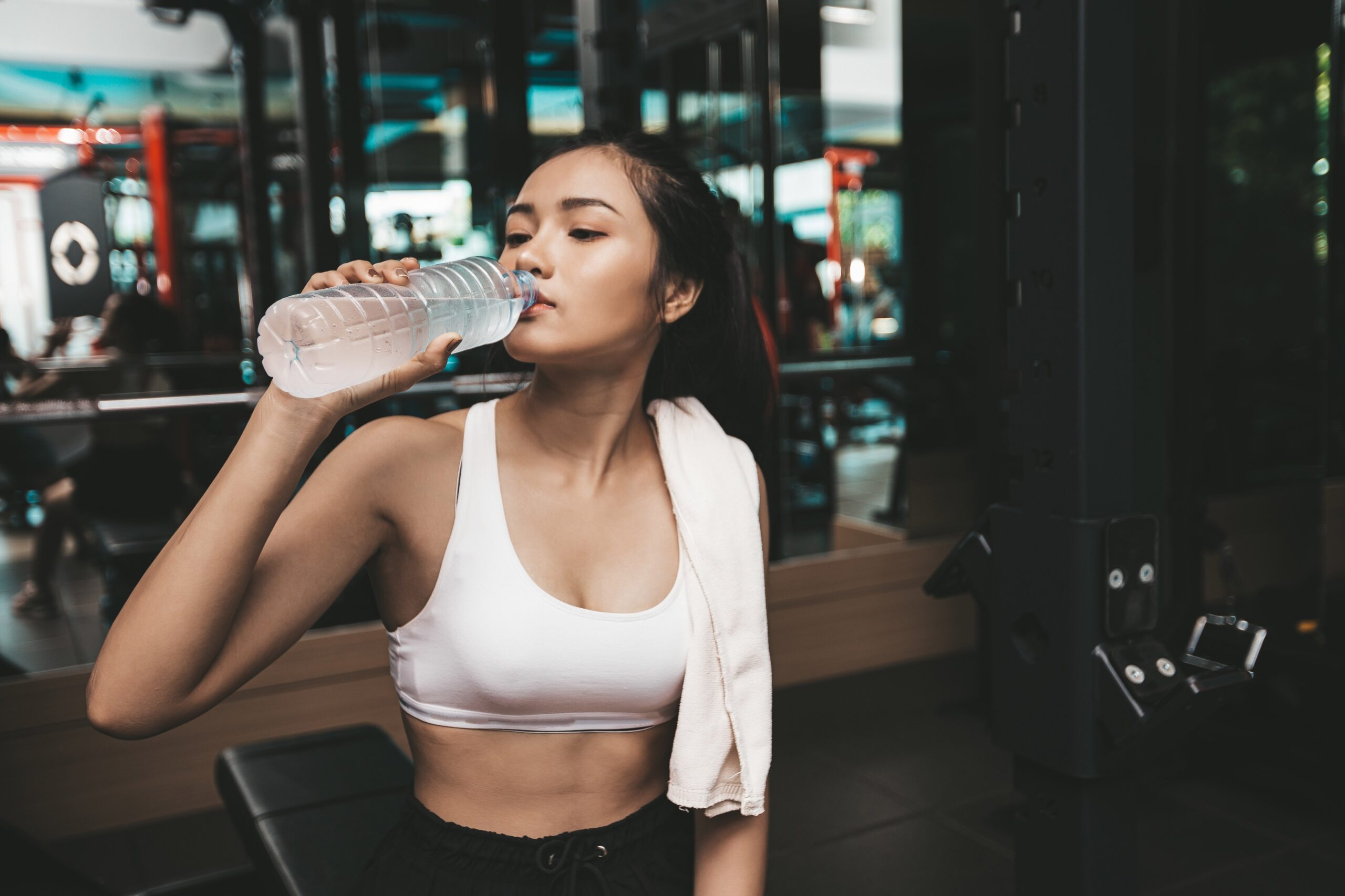 what to drink after workout - woman drinking post workout drink after exercise